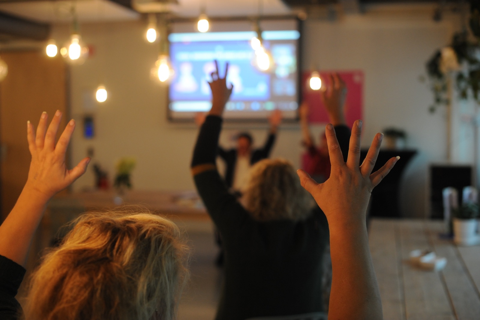 Participants raising their arms during an in-company Business Yoga workshop